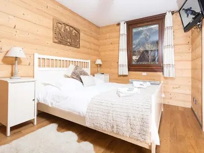 a bedroom with a white bed and a window at Apartment Le Paradis 8 Wohnung by Interhome in Chamonix-Mont-Blanc
