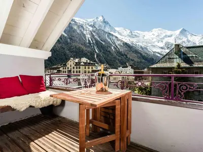 a balcony with a table and a view of mountains at Apartment Villa Vallet Wohnung by Interhome in Chamonix-Mont-Blanc