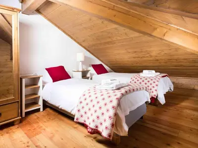 two beds in a attic room with wooden ceilings at Apartment Villa Vallet Wohnung by Interhome in Chamonix-Mont-Blanc