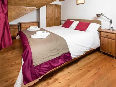 a bedroom with a large bed with red pillows at Apartment Villa Vallet Wohnung by Interhome in Chamonix-Mont-Blanc