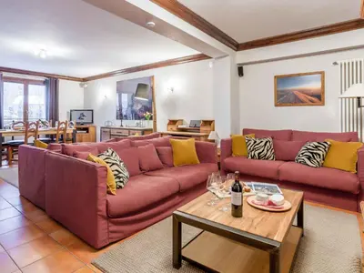 a living room with two red couches and a table at Apartment Apothekerwohnung by Interhome in Chamonix-Mont-Blanc