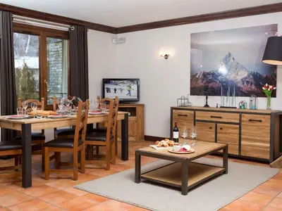 a dining room with a table and a tv at Apartment Apothekerwohnung by Interhome in Chamonix-Mont-Blanc