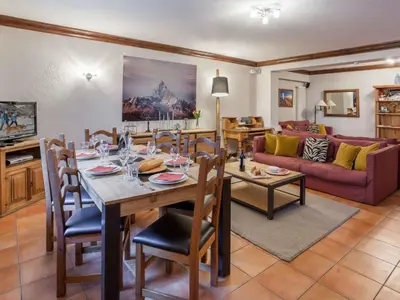 a dining room and living room with a table and chairs at Apartment Apothekerwohnung by Interhome in Chamonix-Mont-Blanc