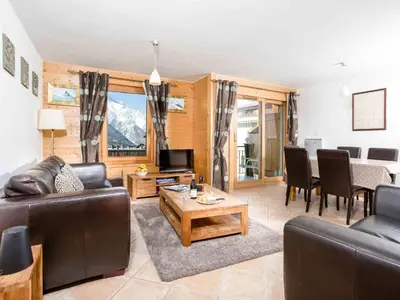 a living room with a couch and a table at Apartment Die Sonnailles apartment by Interhome in Chamonix-Mont-Blanc