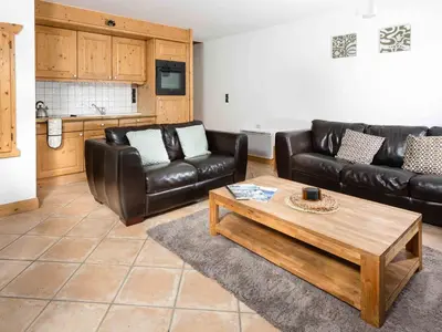 a living room with leather furniture and a coffee table at Apartment Die Sonnailles apartment by Interhome in Chamonix-Mont-Blanc