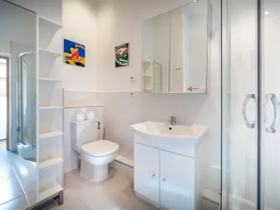 a white bathroom with a toilet and a sink at Apartment Rupicapra Wohnung by Interhome in Chamonix-Mont-Blanc