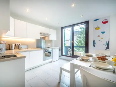 a kitchen with white appliances and a large window at Apartment Rupicapra Wohnung by Interhome in Chamonix-Mont-Blanc