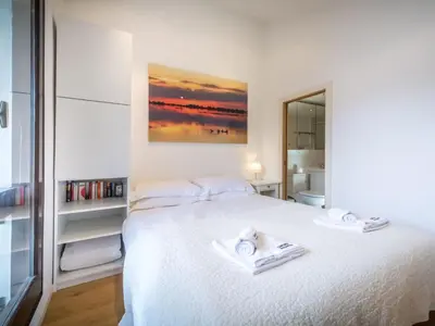 a bedroom with a white bed with towels on it at Apartment Rupicapra Wohnung by Interhome in Chamonix-Mont-Blanc