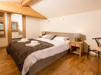a bedroom with a large bed with towels on it at Holiday Home Chalet des Souchettes by Interhome in Chamonix-Mont-Blanc