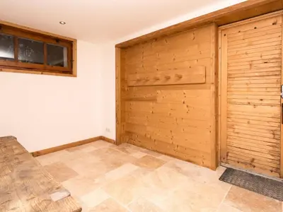 a room with a wooden door and a tile floor at Holiday Home Chalet des Souchettes by Interhome in Chamonix-Mont-Blanc