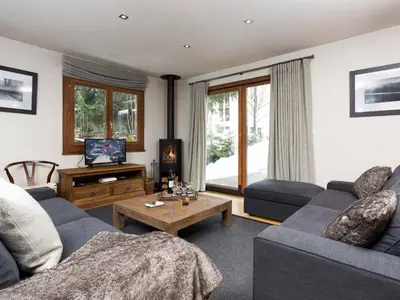 a living room with a couch and a table at Holiday Home Chalet des Souchettes by Interhome in Chamonix-Mont-Blanc