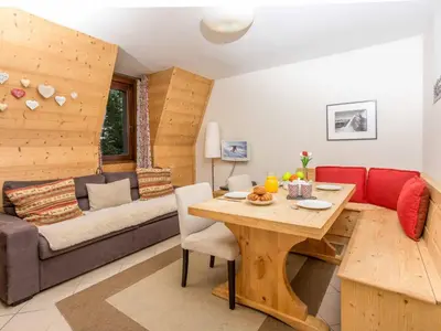 a living room with a table and a couch at Apartment Angenehme Wohnung in Chamonix Centre-Ville by Interhome in Chamonix-Mont-Blanc