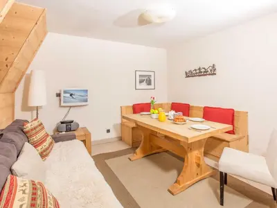 a living room with a table and a couch at Apartment Angenehme Wohnung in Chamonix Centre-Ville by Interhome in Chamonix-Mont-Blanc