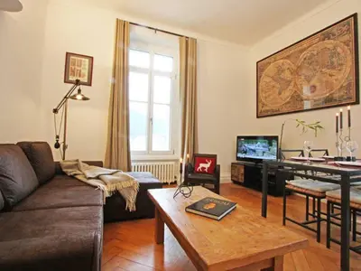 a living room with a couch and a table at Apartment Wohnung Alpines Museum by Interhome in Chamonix-Mont-Blanc