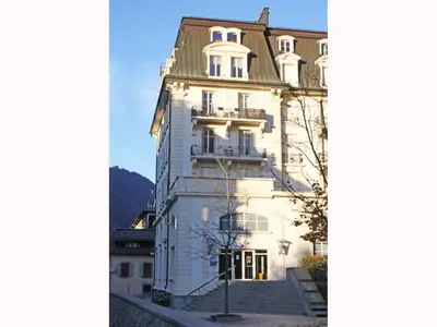 a large white building with a green roof at Apartment Wohnung Alpines Museum by Interhome in Chamonix-Mont-Blanc