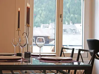 a dining room table with wine glasses and a window at Apartment Wohnung Alpines Museum by Interhome in Chamonix-Mont-Blanc