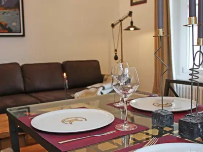a table with two plates and wine glasses on it at Apartment Wohnung Alpines Museum by Interhome in Chamonix-Mont-Blanc
