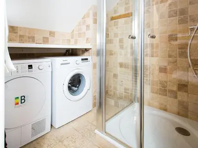 a bathroom with a washing machine and a shower at Apartment Die Belle Epoque Wohnung by Interhome in Chamonix-Mont-Blanc