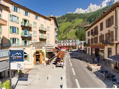 a street in a town with buildings and a mountain at Apartment Die Belle Epoque Wohnung by Interhome in Chamonix-Mont-Blanc