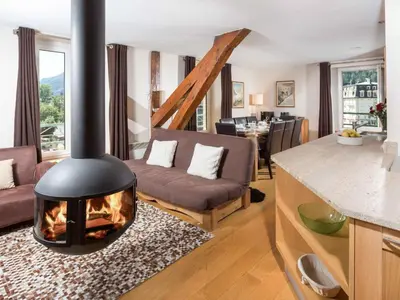 a kitchen and living room with a fireplace at Apartment Die Belle Epoque Wohnung by Interhome in Chamonix-Mont-Blanc