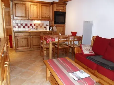 a kitchen with a couch and a table in a room at Appartement 6 pers, proche centre Samoëns, parking inclus - FR-1-815-115 in Samoëns