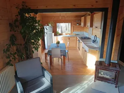 a kitchen and dining room with a table and a refrigerator at Chalet vue panoramique in Passy