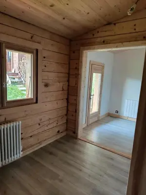 a living room with a couch and a window at Chalet vue panoramique in Passy