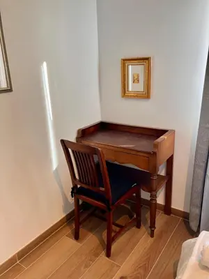 a wooden piano in a room with a wooden chair at Calm & Cozy Apartment with Parking in Sallanches in Sallanches