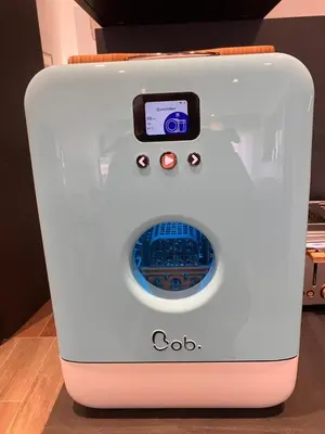 a white washing machine with a box on top of it at Calm & Cozy Apartment with Parking in Sallanches in Sallanches