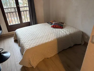 a bedroom with a bed with a pillow on it at Studio 2 personnes situation idéal a Sallanches 74400 in Sallanches