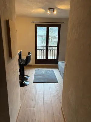 a living room with a desk and a window at Studio 2 personnes situation idéal a Sallanches 74400 in Sallanches