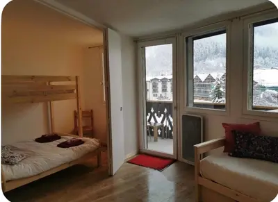 a bedroom with a bunk bed and a window at Jonquille 5 personnes in Chamonix-Mont-Blanc