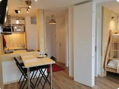 a small kitchen with a table and a kitchen with a bed at Jonquille 5 personnes in Chamonix-Mont-Blanc