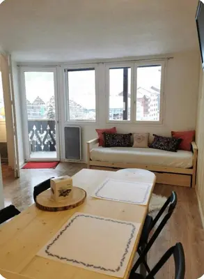 a living room with a couch and a table at Jonquille 5 personnes in Chamonix-Mont-Blanc
