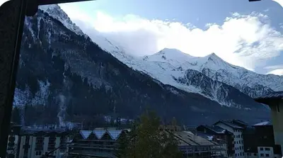 a view of a snow covered mountain with a city at Jonquille 5 personnes in Chamonix-Mont-Blanc
