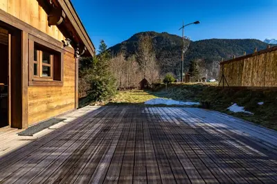a wooden walkway next to a building with a mountain at Tiny Chalet - near to Servoz train station in Les Houches