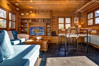 a living room with a couch and a table at Tiny Chalet - near to Servoz train station in Les Houches
