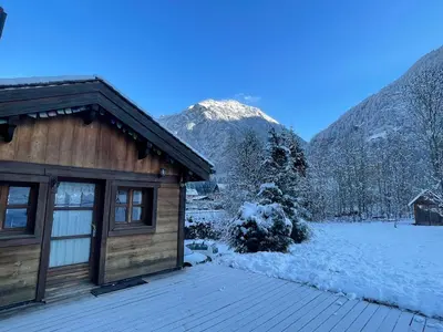 a cabin in the mountains with snow on the ground at Tiny Chalet - near to Servoz train station in Les Houches