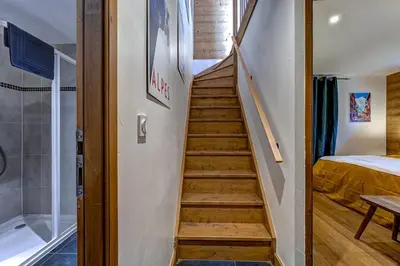 a stairway leading to a bedroom and a bathroom at Tiny Chalet - near to Servoz train station in Les Houches