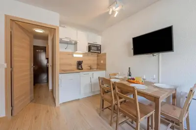a kitchen and dining room with a table and chairs at Chamonix Sud - Grepon 104 - Happy Rentals in Chamonix-Mont-Blanc