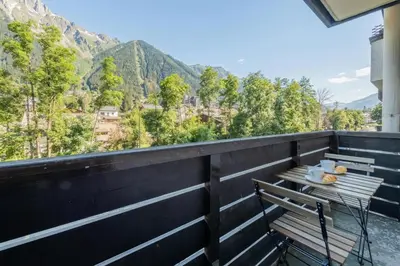 a bench on a balcony with a view of mountains at Chamonix Sud - Grepon 104 - Happy Rentals in Chamonix-Mont-Blanc