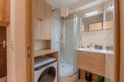 a bathroom with a shower and a washing machine at Chamonix Sud - Grepon 104 - Happy Rentals in Chamonix-Mont-Blanc