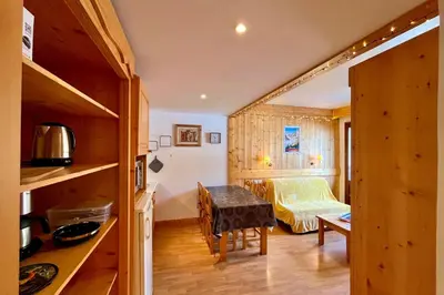 a small room with a table and a bedroom at Escape Mountain Apartment with Stunning Views in Combloux