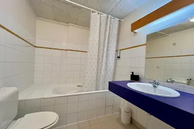 a bathroom with a toilet and a sink and a tub at Escape Mountain Apartment with Stunning Views in Combloux