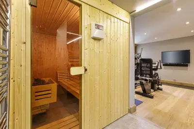 a room with a gym with a wooden wall at Megepi Chalet 5CH Calme Remontee 400m Sauna Fitness in Demi-Quartier