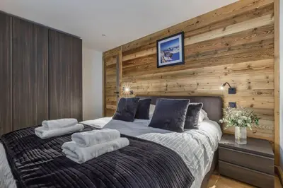 a bedroom with a large bed with towels on it at Jacaranda 5 - Sublime 6pax - Central - Confort - Parking in Chamonix-Mont-Blanc