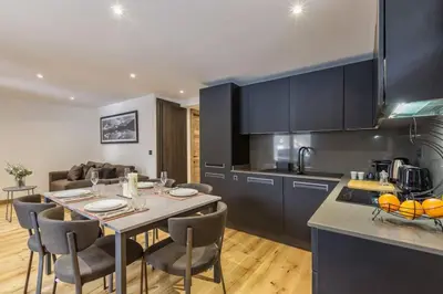 a kitchen with a table and chairs in a room at Jacaranda 5 - Sublime 6pax - Central - Confort - Parking in Chamonix-Mont-Blanc