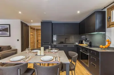 a kitchen with a table and chairs in a room at Jacaranda 5 - Sublime 6pax - Central - Confort - Parking in Chamonix-Mont-Blanc