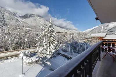 a balcony with a view of a snow covered mountain at Les Choucas Spacieux 2CH Parking Calme Vues 5mn centre in Chamonix-Mont-Blanc
