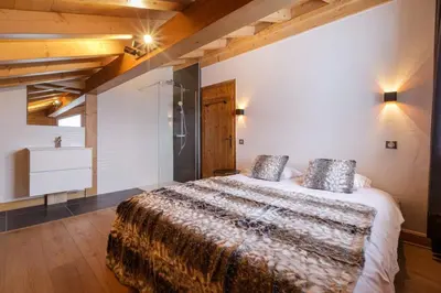 a bedroom with a large bed in a room at Grosse Pierre Chalet 180m2 Cheminee Jacuzzi Vue Taconnaz in Les Houches
